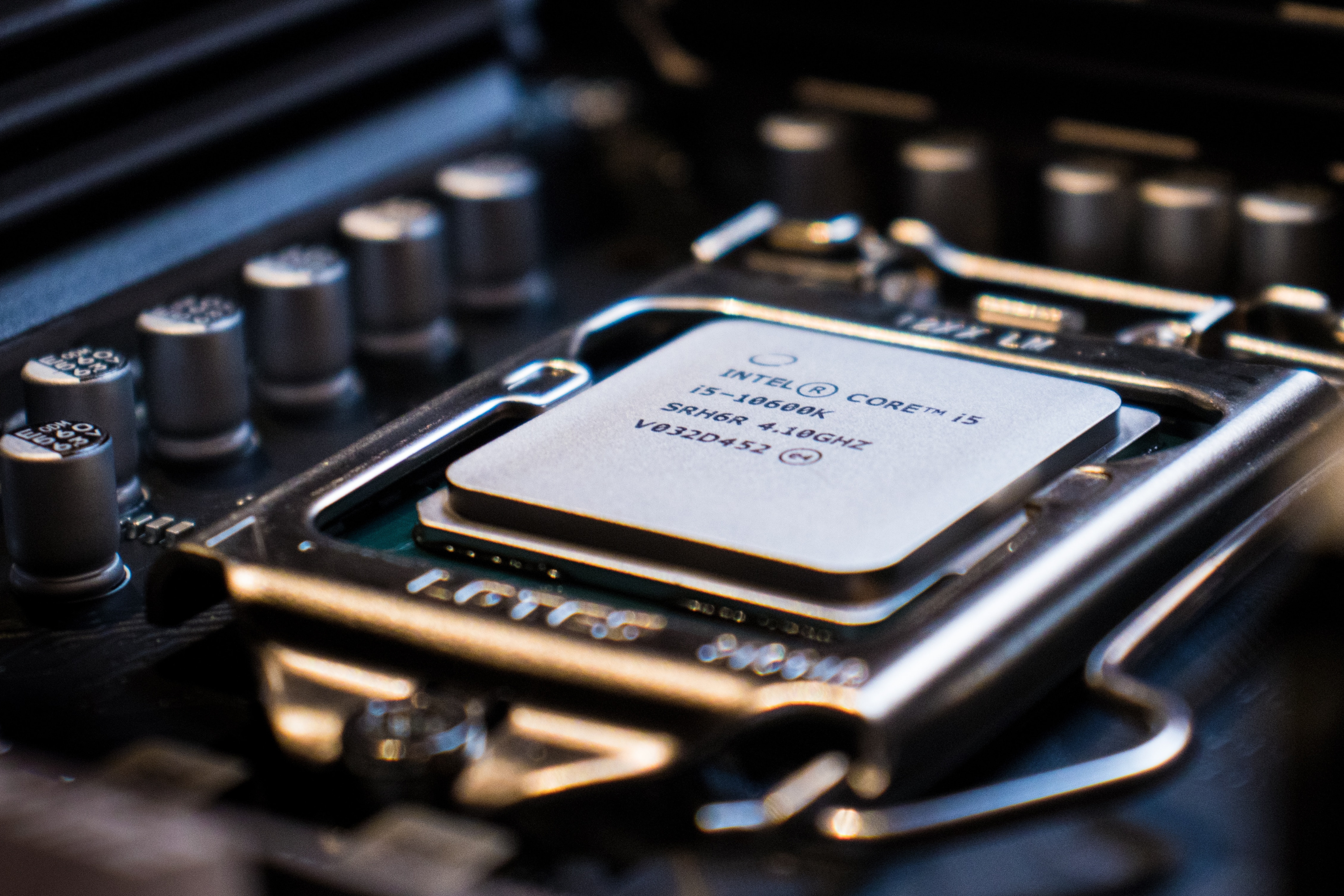 A close-up image of a CPU core i5, docked on a motherboard with the background blurred