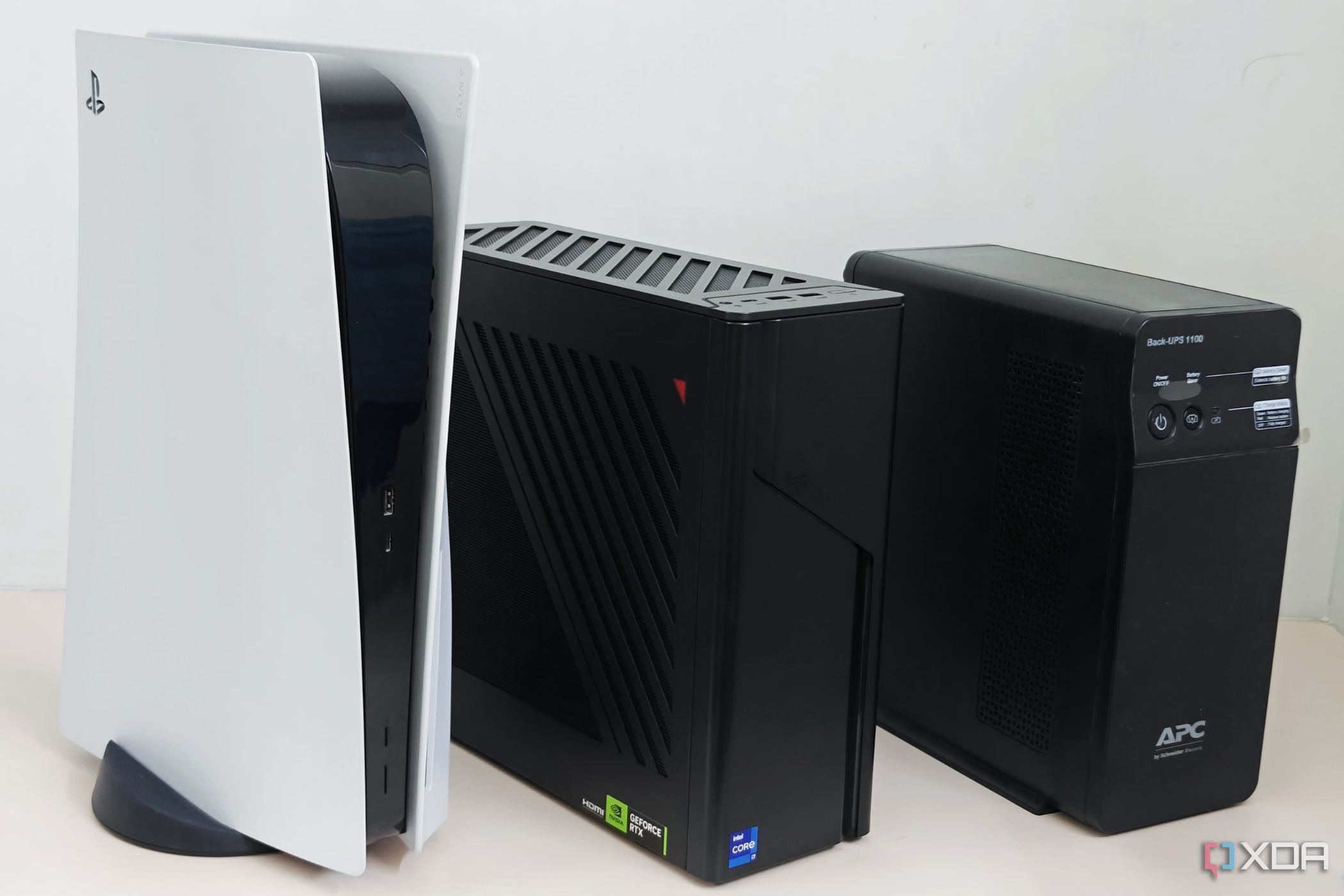 An image showing the size comparison of the G22CH with PS5 and a UPS.