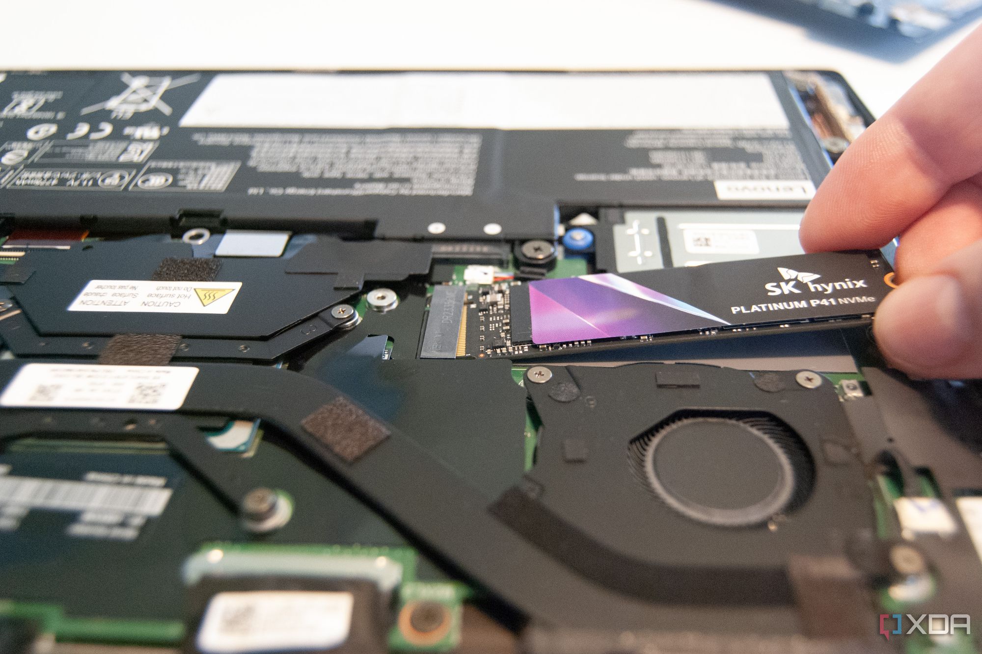 Slide the new SSD into the slot at a 20-degree angle