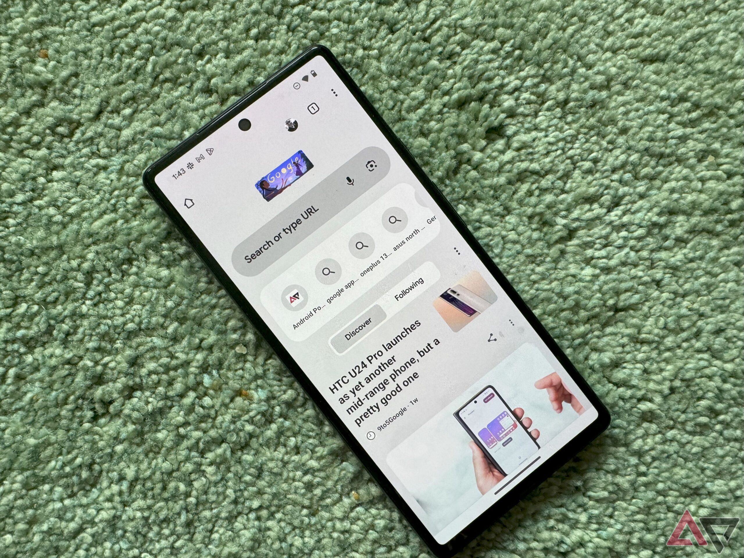 A Pixel on a green carpet with the Google Chrome app open on the homepage.