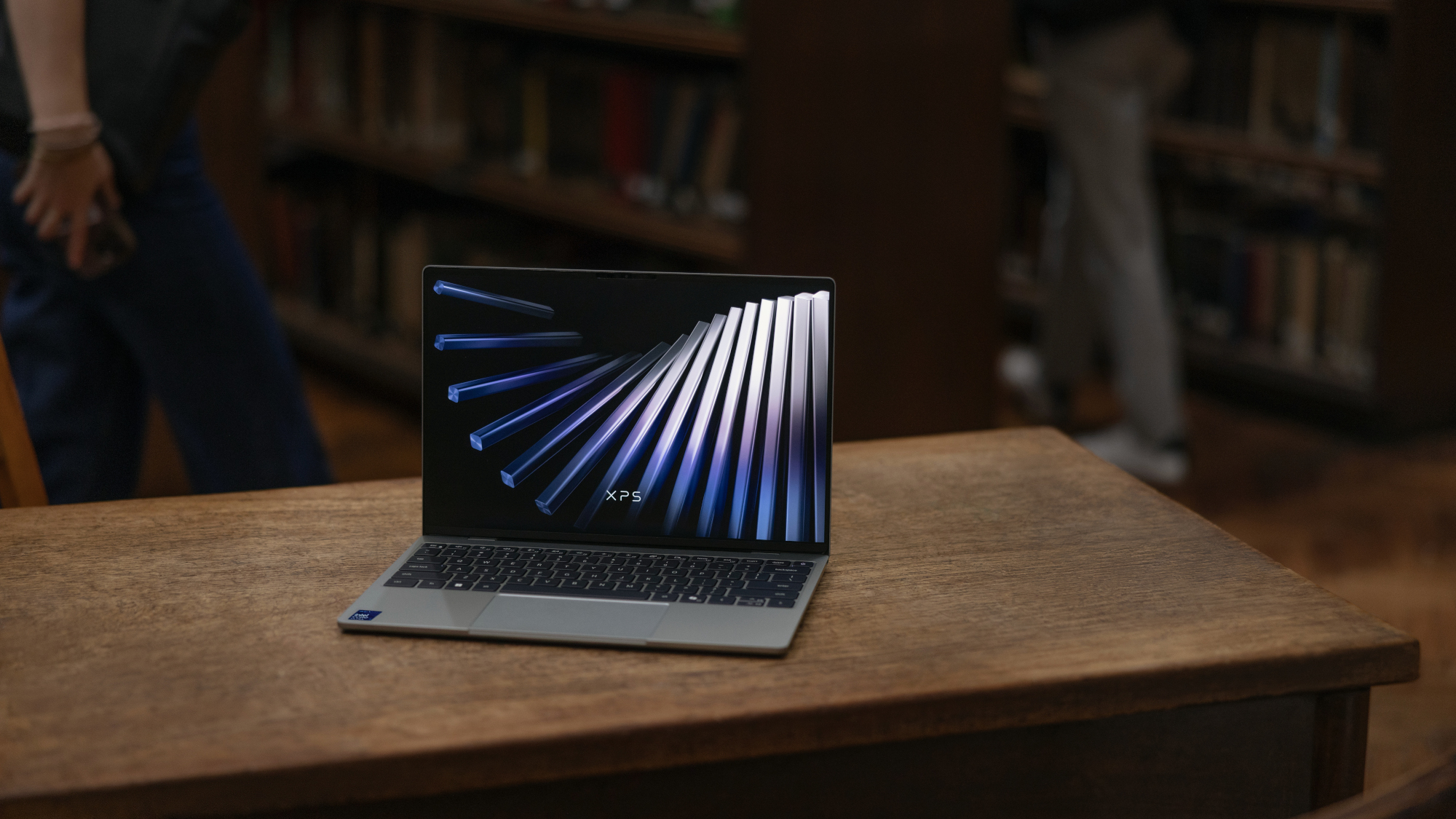 Dell XPS 13 laptop on a desk in a library